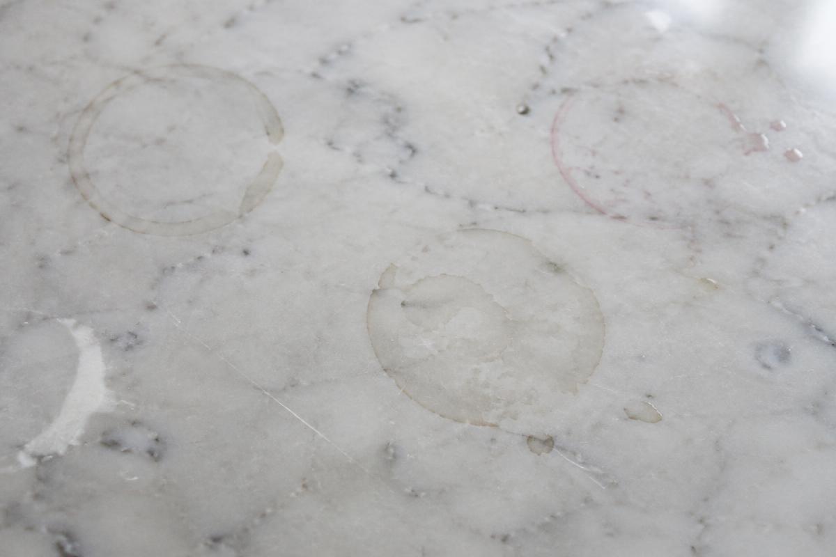 White marble countertop — before, showing etch rings